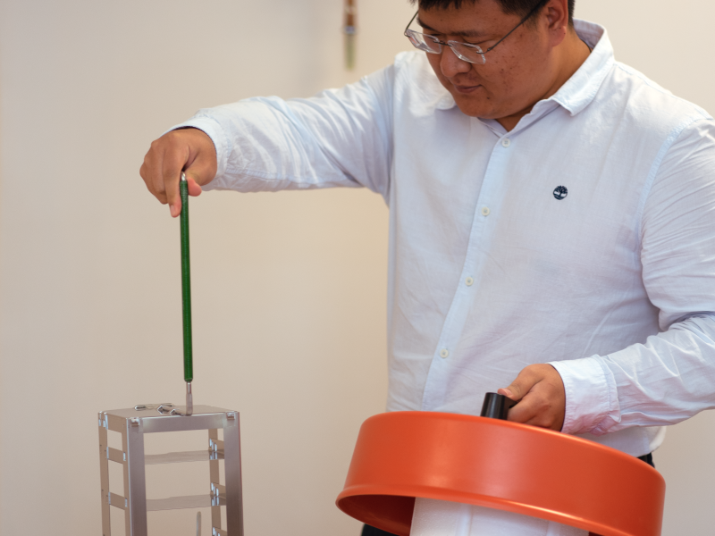 Kenan placing biological samples into frozen nitrogen tank