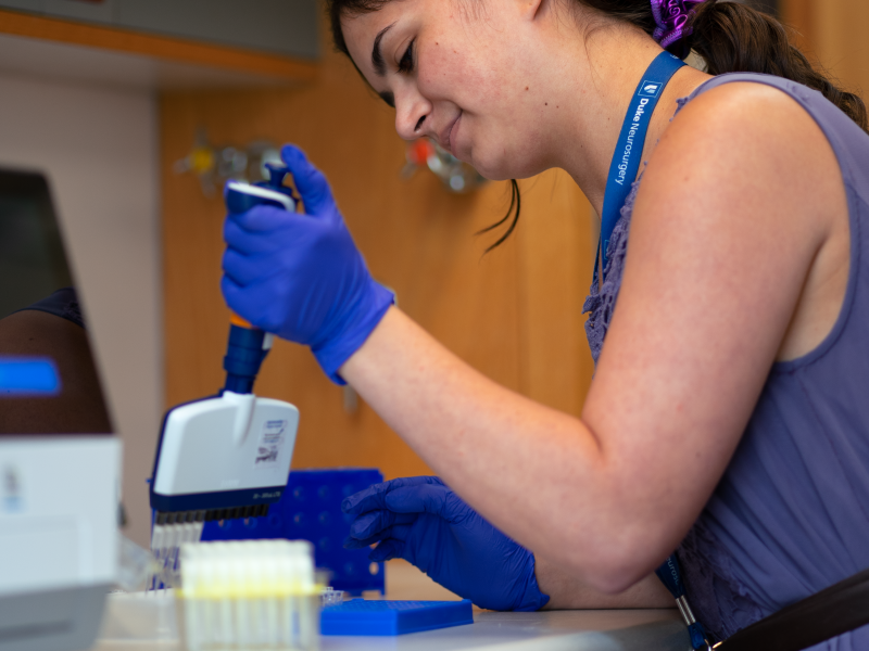 Chelsea using a multichannel pipette to transfer biological samples into collection tubes