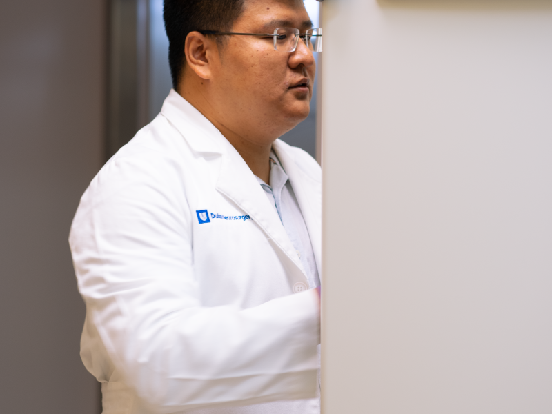 Kenan adding samples to laboratory freezer