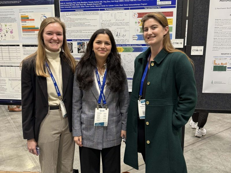Chelsea, Emily, and Kelly standing in front of poster presentation at SNO 2023